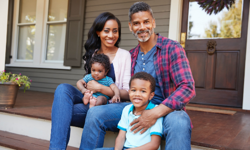 family sitting together on front porch