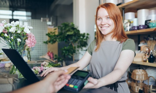 cashier woman selling flowers in shop