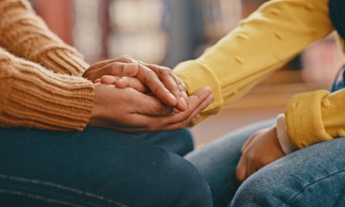 People holding hands during a time of crisis