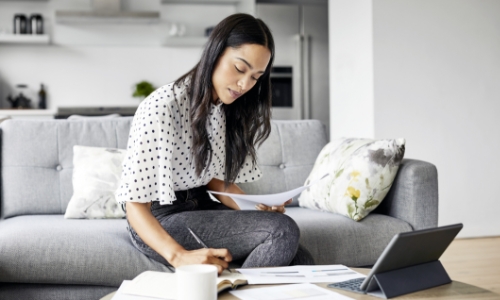 Woman filling out a budget for expenses