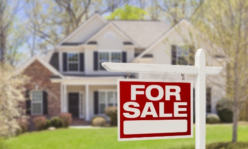 For sale sign in front of a house