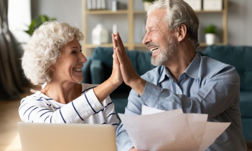 A couple celebrating their mortgage loan decision