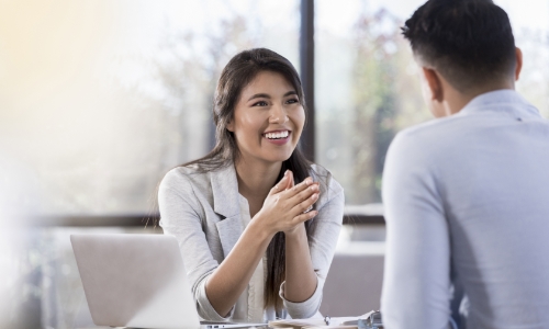 A financial advisor giving a young person investing advice