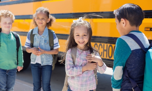 Kids waiting to get on the school bus