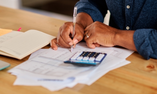 A person filling out tax forms