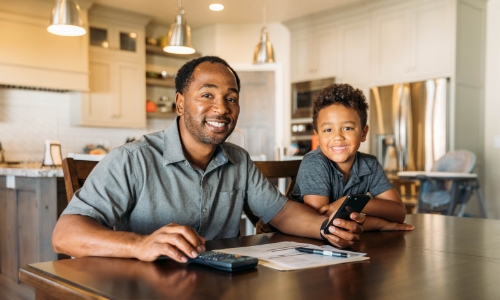 A parent and child working on a budget together