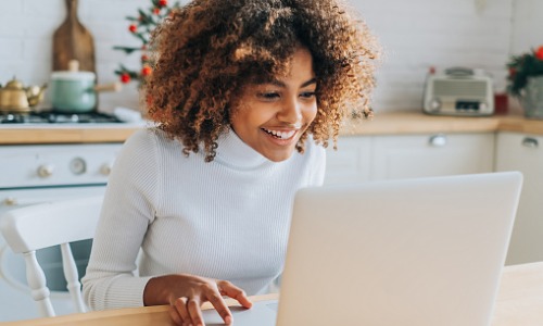 woman looking at laptop and enjoying online shopping