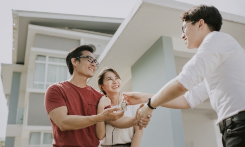 A couple being handed the keys to their new home