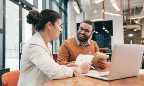 Two employees discussing business plans