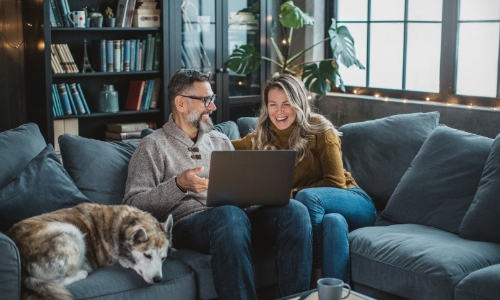 A couple sitting on the couch discussing retirement options