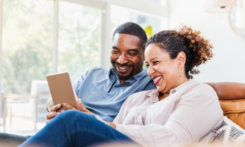 A couple looking at their bank account online