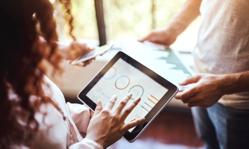 A business owner looking at analytics reports on a tablet