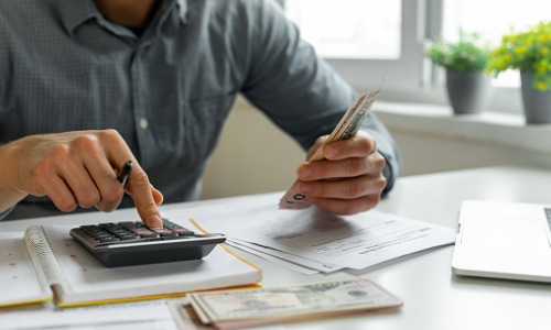 Man using calculator 