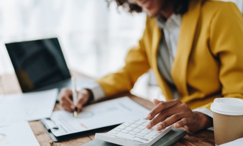 Woman working on her taxes at a desk