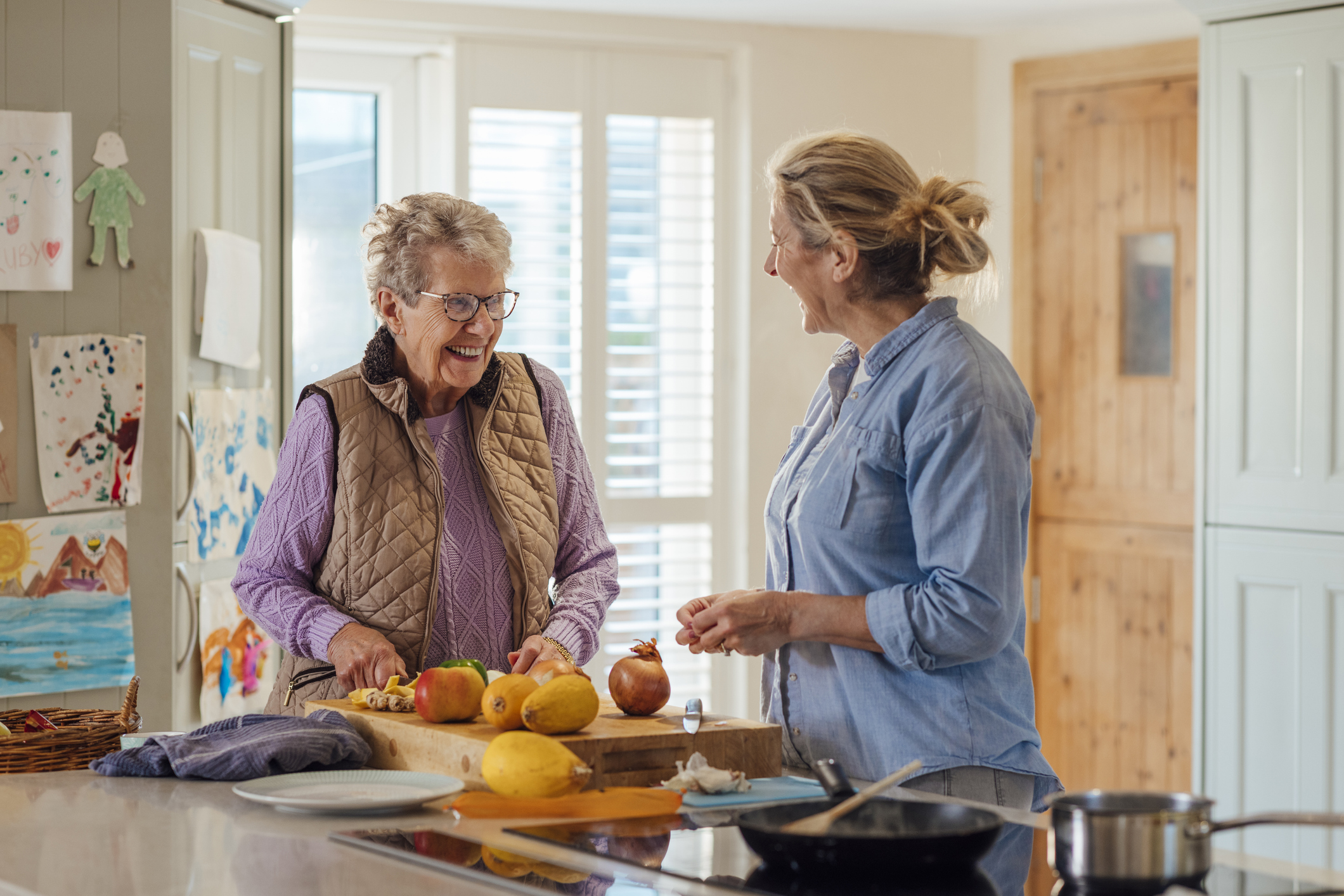 Mother and daughter cooking in kitchen