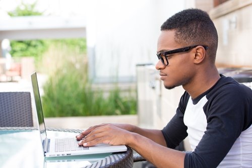 A man using his laptop to file small business taxes