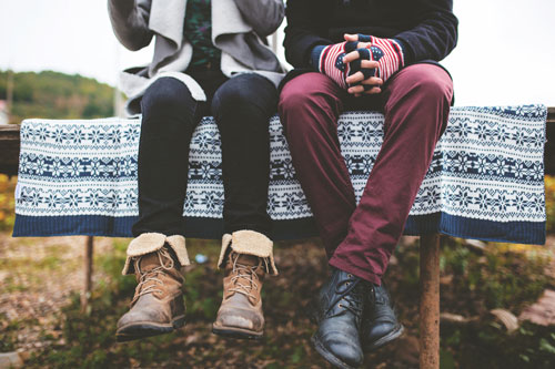 People sit together with clothing on for colder weather