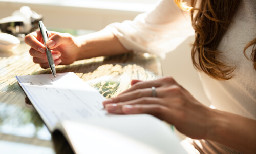 A person writing out a check