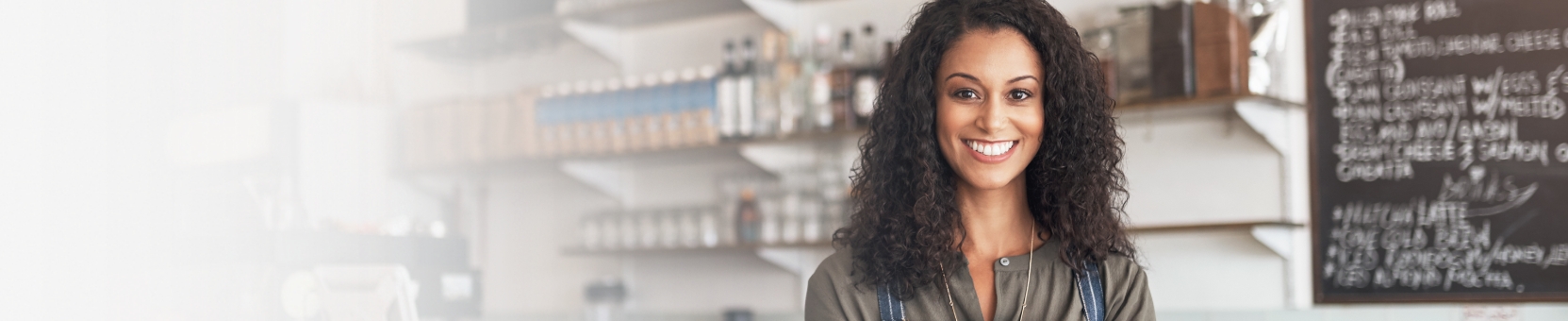 Business owner standing behind counter