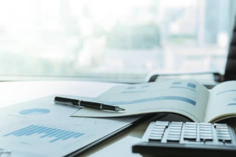 Paperwork and a calculator being used to figure out a money market account