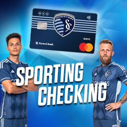 Johnny Russell holding a KC Sporting Debit Card