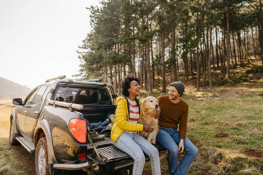 Couple with their dog sitting outside