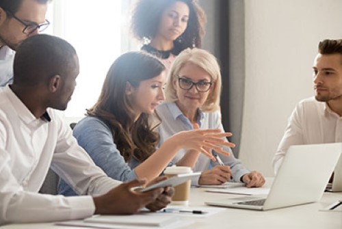 Group of people collaborating around a table