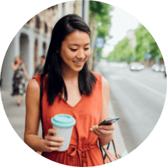 woman holding phone and coffee