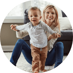 mother helping baby walk on own