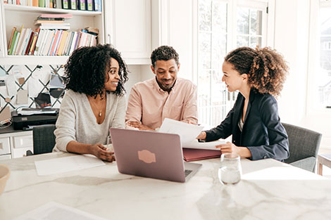 a couple sitting down with their financial advisor