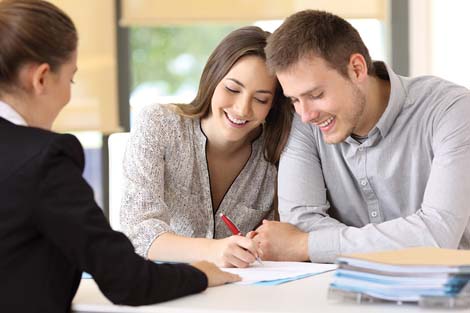 Couple signing paperwork